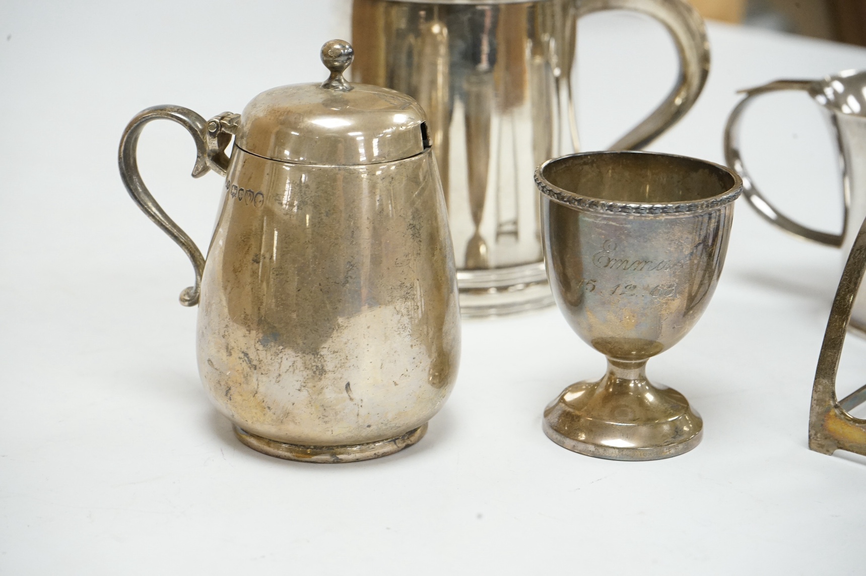 Small silver including a mug, Collingwood & Co, London, 1946, 87mm, a late Victorian mustard pot, toast rack, egg cup and an 830 standard white metal mug, 18oz. Condition - fair.